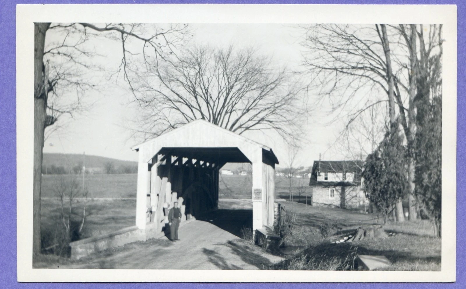 Historic black-and-white covered bridge photograph