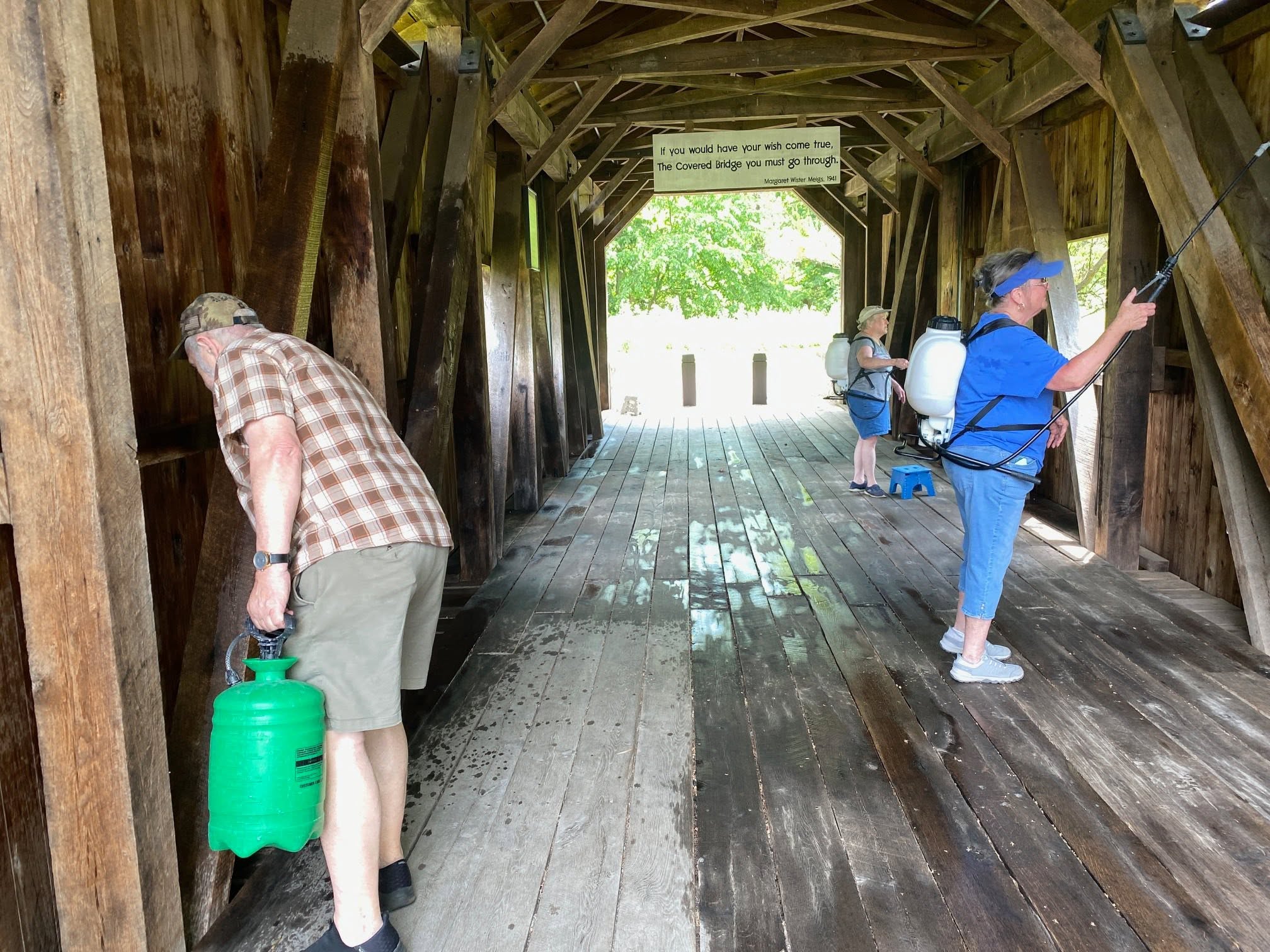 Society members applying NoChar fire retardant inside Fort Hunter Covered Bridge